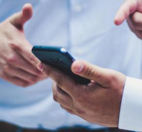 Captivated Duo Engrossed in Single Smartphone Screen