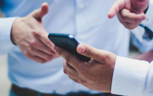 Captivated Duo Engrossed in Single Smartphone Screen